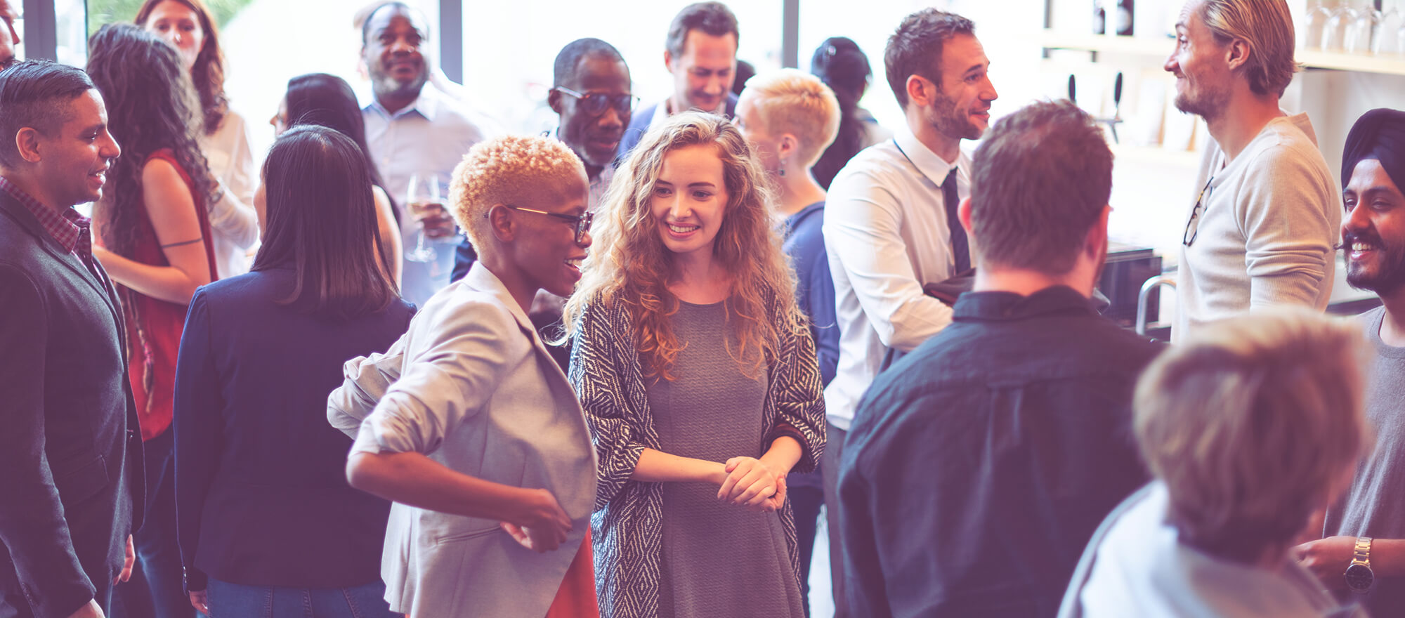 Recruitment professionals networking at a business event, building connections and discussing opportunities in the recruitment industry.