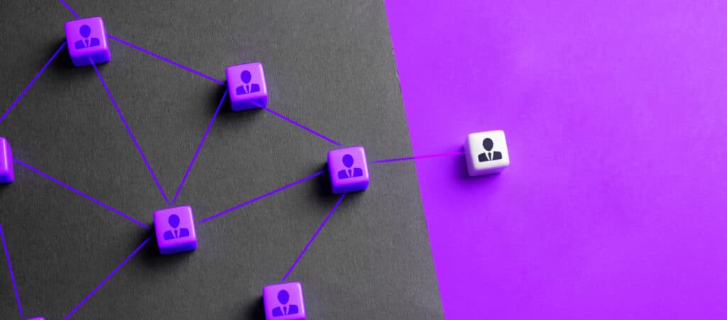 A network of employees with connecting lines, with one leading to an external resource on a purple background, conceptualising outsourcing back office services.