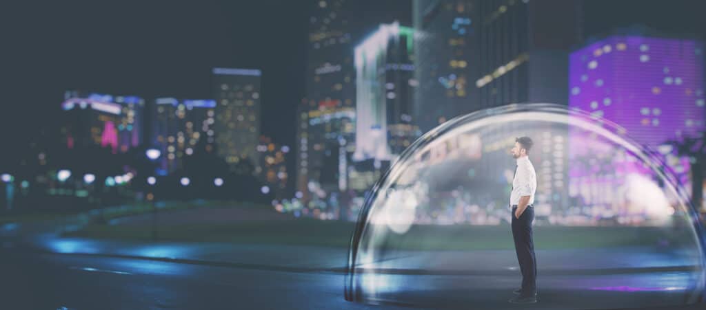 A businessman standing safely inside a protective glass dome against a night-time city skyline, symbolising how recruitment agencies can use professional accountancy services and expert bookkeeping to shield their business from client risk.