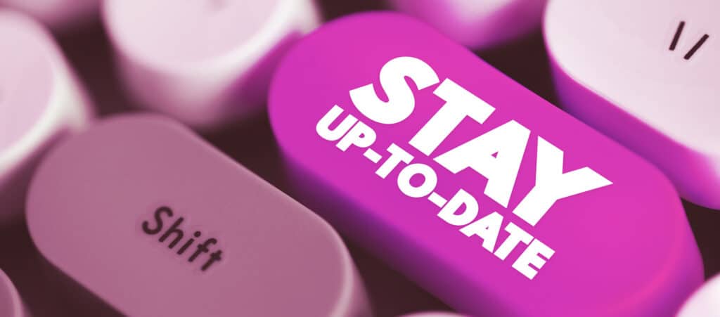 A pink computer keyboard button reading 'STAY UP-TO-DATE' used to highlight recruitment agency bookkeeping and financial reporting analysis.