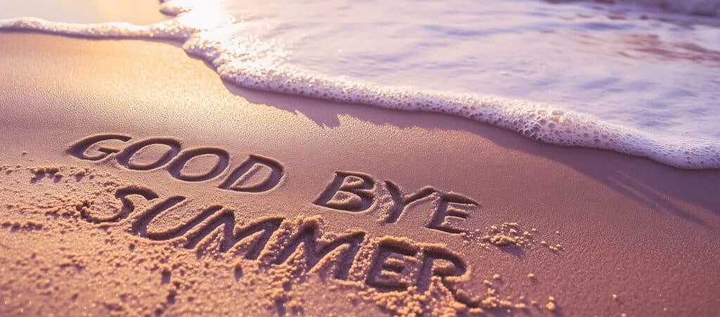 Words 'Good Bye Summer' written in beach sand with a sea wave, used for a recruitment agency startup blog.