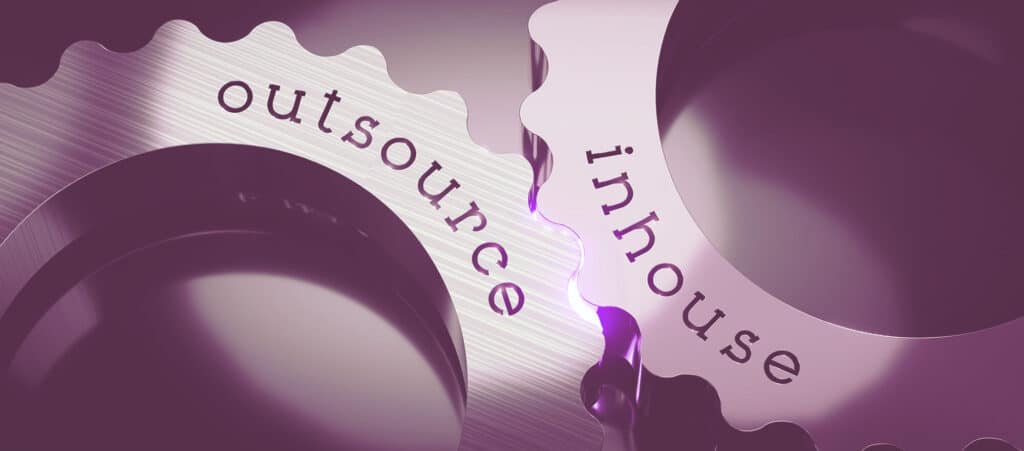 Interlocking metal cogs engraved with outsource and inhouse text, illustrating recruitment agency accounting options.