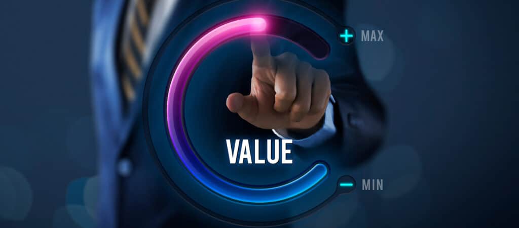 A businessman turning a digital dial to maximum value, illustrating strategies to increase recruitment agency valuation.